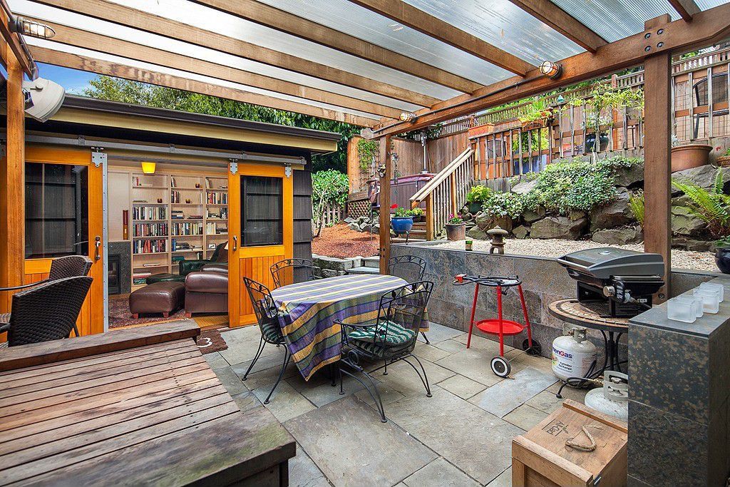 Eclectic Porch Seattle Eclectic Porch with Outdoor kitchen, Raised beds, Trellis, exterior stone floors, Fence