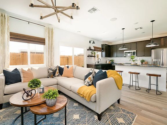 Great room with chandelier and tile flooring