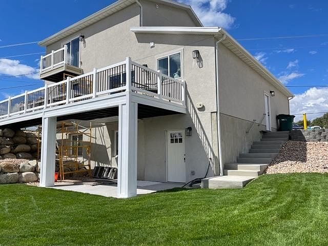 Apartment entrance and yard. Note the covered patio (construction scaffolding will be gone).
