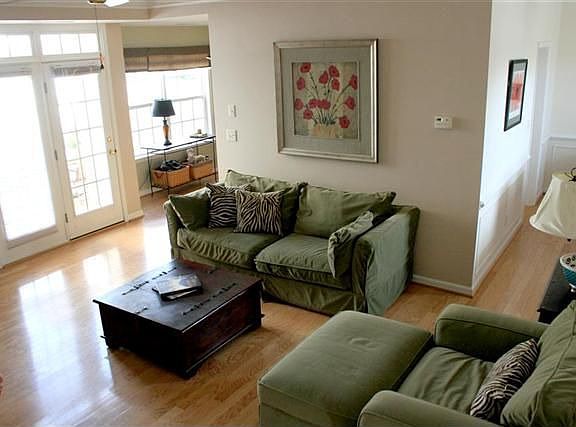 Open living room with high ceilings. Hardwoods throughout the main living area