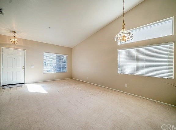 Large living room with plenty of natural light and high ceilings