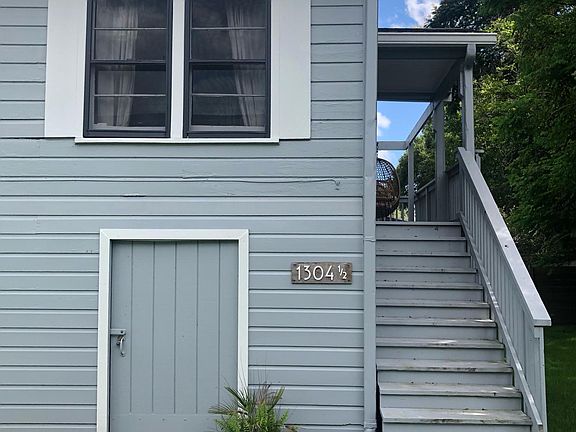 Living unit is on second floor. The door on the ground level accesses the storage space and private washer/dryer.