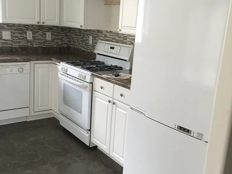 Updated kitchen white cabinets and decor tile backsplash