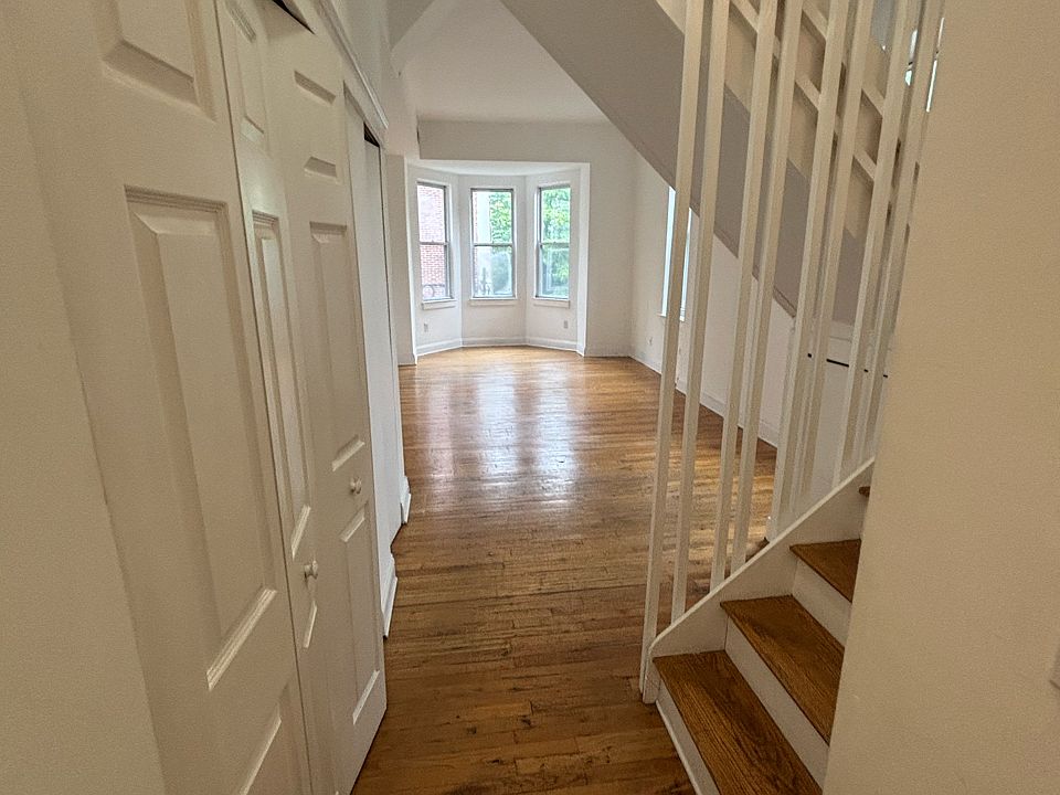 Entry hall, closet and washer/dryer on left, kitchen to right