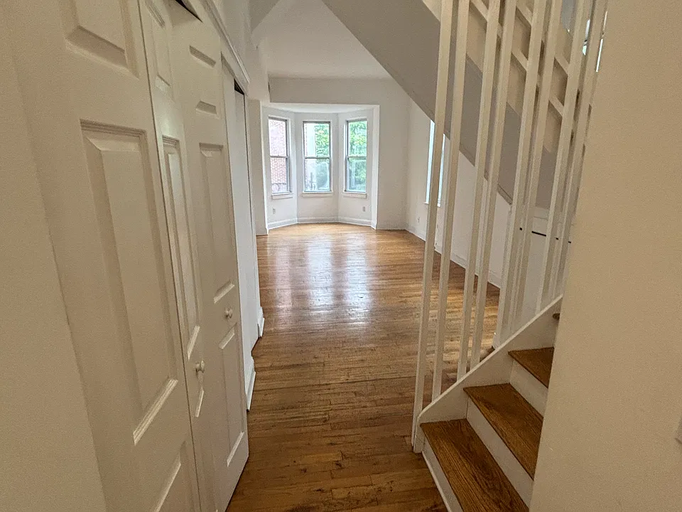 Entry hall, closet and washer/dryer on left, kitchen to right