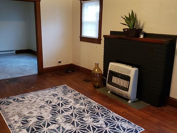 Living room looking from the front door. Gas heat insert.