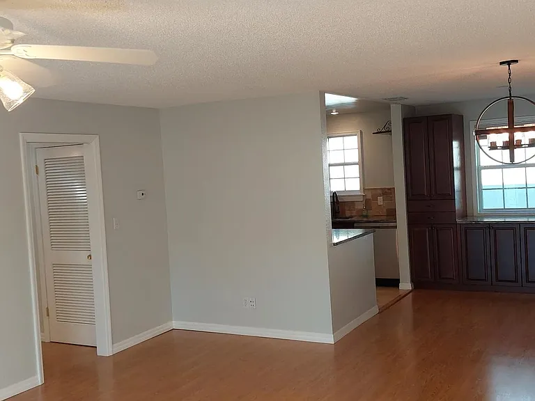 Main room with hallway entrance to bedrooms on the left.