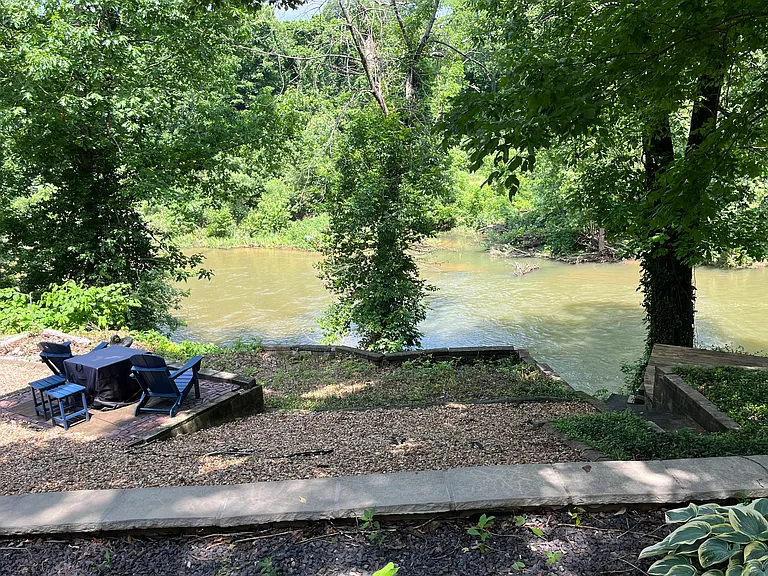 Gravel firepit area with river access.