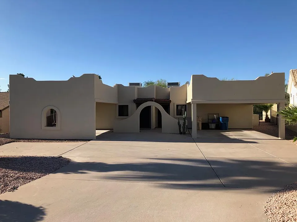 Front view from street -- all new stucco, windows and doors.