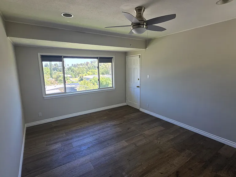 Large Bedroom on second floor with view and door to access wrap around glass balcony.
