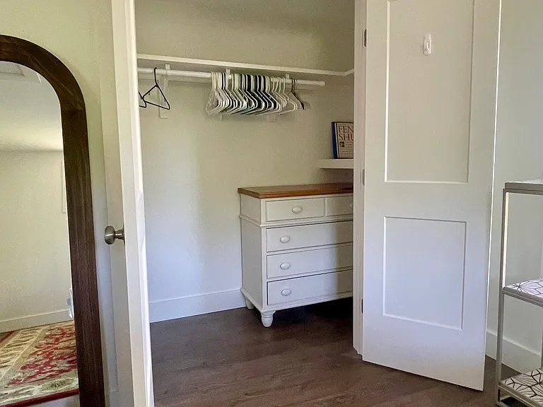Bedroom with dresser and large closet.