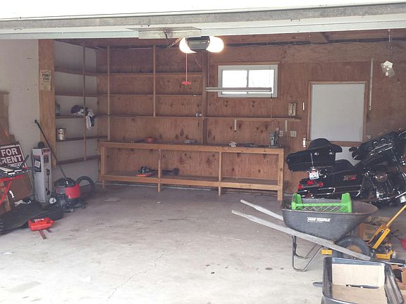 Two car garage with built in shelves and opener.  Motion det