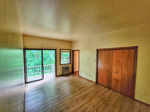 large closet in bedroom with sliding glass door to deck