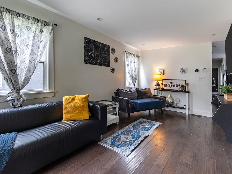Bathed in natural light from three large windows, this bright and airy living room is perfect for relaxing with friends or family after a day out __