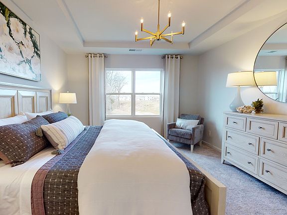 Elegant owner s suite with a tray ceiling.