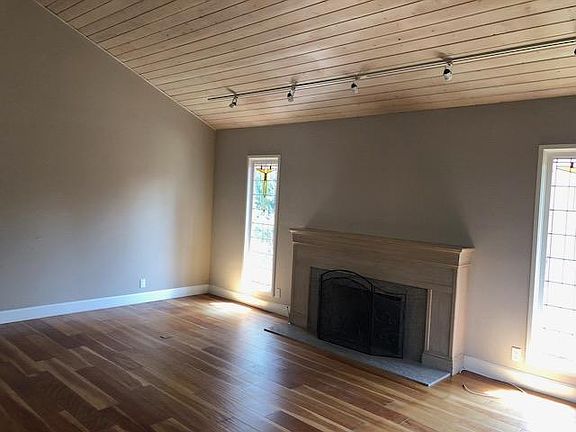 Living area with fireplace and stained glass windows.