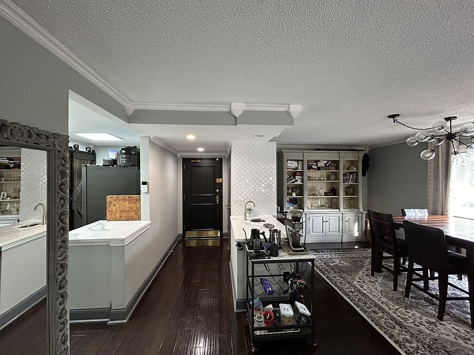 Grey full-wall armoire shelving remains in unit