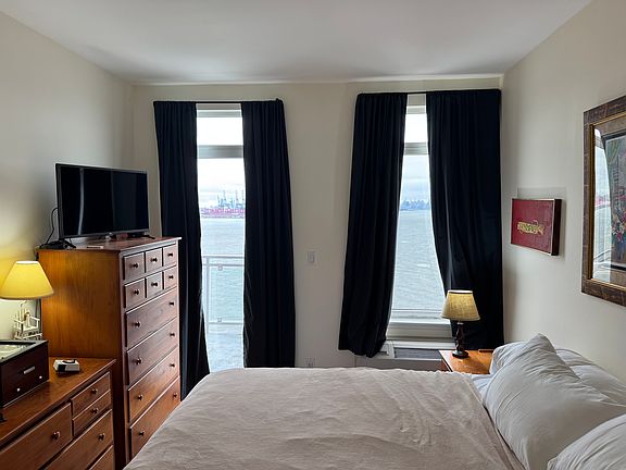 The master bedroom with balcony door, window, and superb views. King size bed shown (not included).
