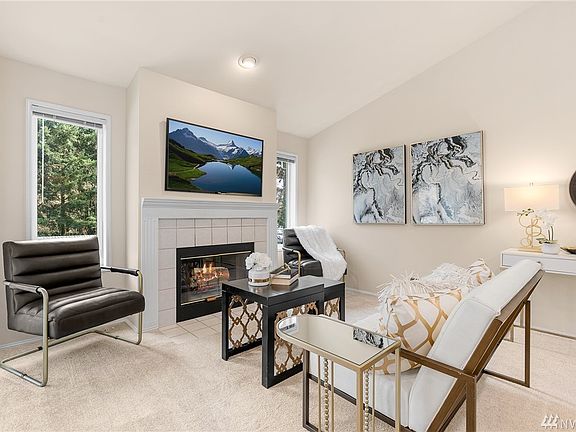 Living room with wood-burning fireplace.