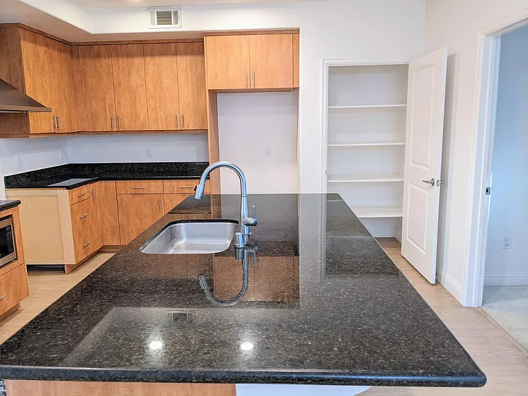Large kitchen island and pantry with lots of space to store items.