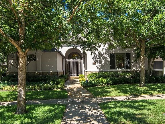 Mature trees and elegant front elevation.