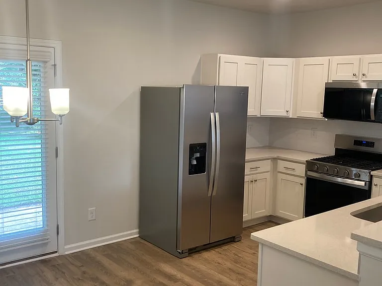 Dining are next to kitchen and with view of the backyard through the french doors to the patio
