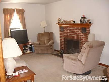 Living room w/ vntd gas brick fireplace.