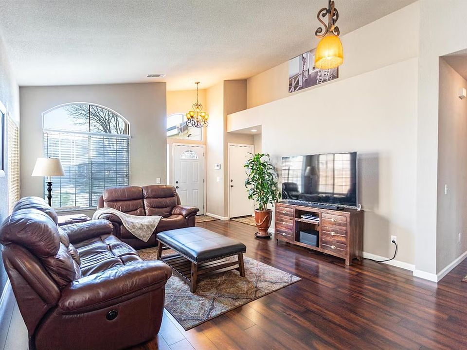 Spacious Living Room with ample natural lights & features 65" Samsung Flatscreen TV & Love Seats & Reclinable Couch.