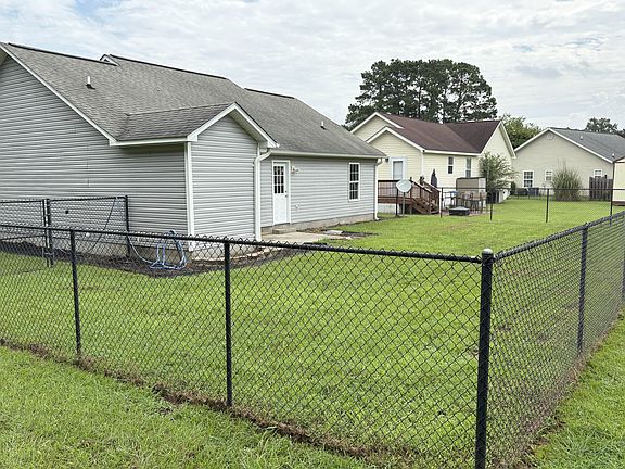 fully fenced back yard w storage shed and patio