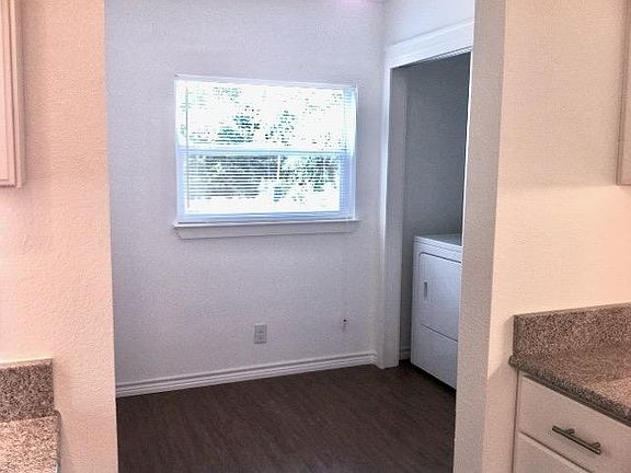 Utility room with washer and dryer and another large closet.