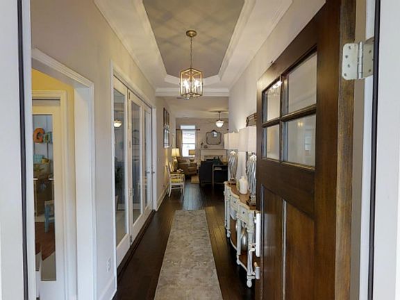 Grand entry with tall trey ceiling. Photo is a representation of home.