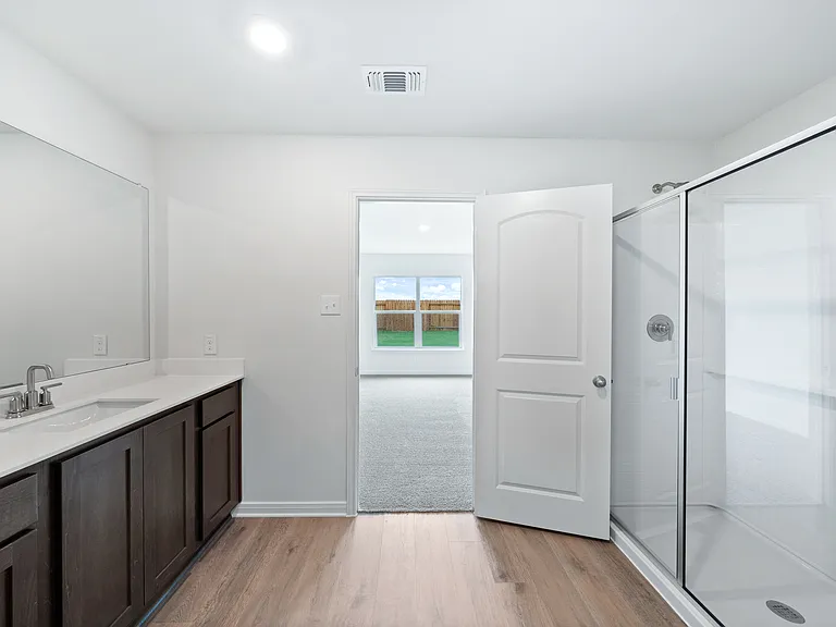 The master bathroom has a large glass, walk-in shower.