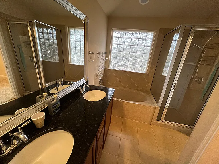 Master bathroom: his and her sinks, bath tub and shower
