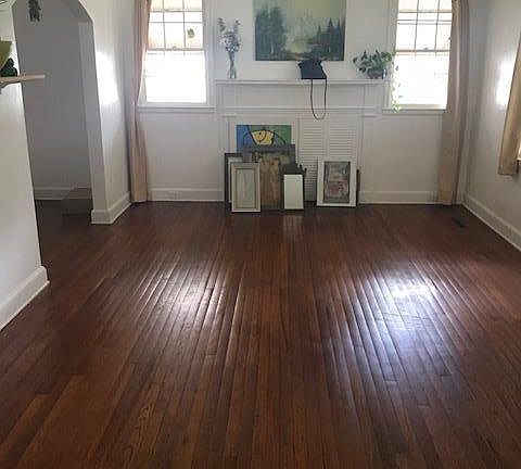 Living room with archway to dining room.