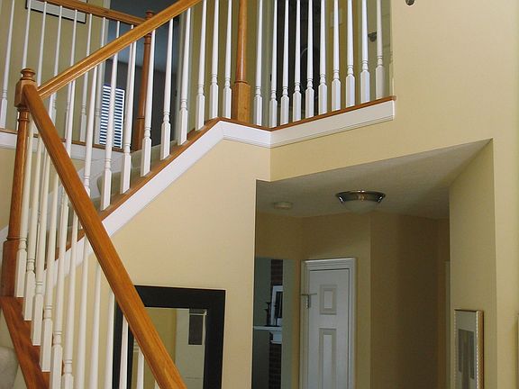 The 2-story foyer warms and welcomes you --and look at that split staircase!
