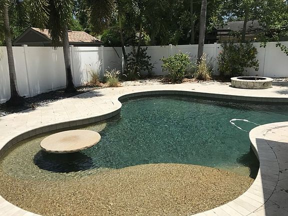 Pool showing bench seating, table and firepit