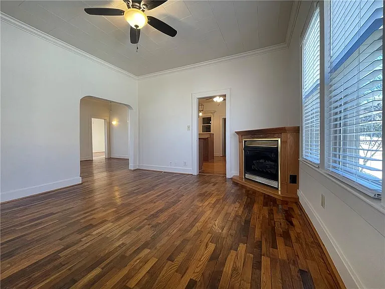 Living Room With Gas Fireplace Looking Into The Kitchen & Dining Room
