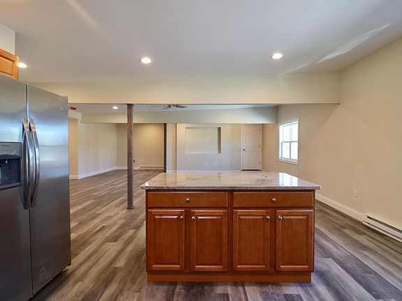 Kitchen w/stainless steel appliances, and granite counter-tops.