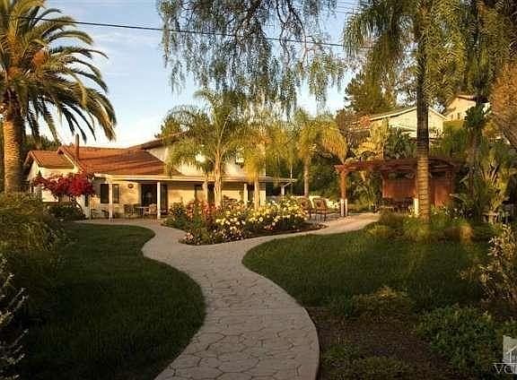 Serenity and privacy in the tranquil, well manicured backyard.