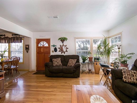 Living room adjacent to dining area.