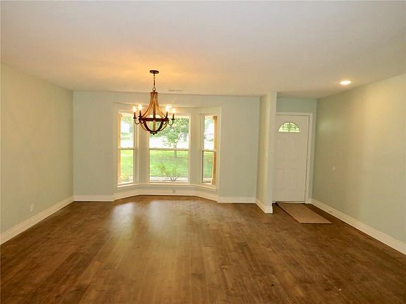 Front door and formal dining room with bay windows.