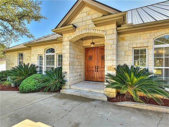 Hand-crafted mesquite doors grace the entrance.  Full, screen covered gutters protect the home.