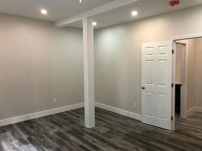 Door leads to foyer with adjacent bathroom.