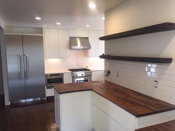 Subway Tile and reclaimed wood floating shelves