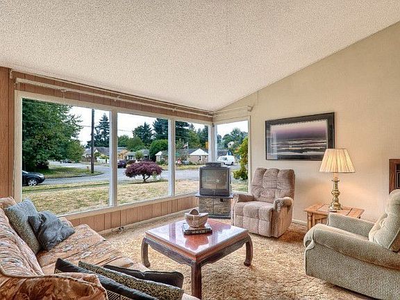 Large picture windows provide plenty of natural light in the open inviting living room with South-We