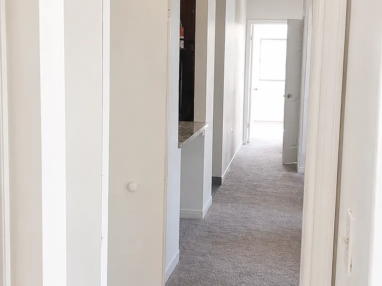 View from the bedroom across to the other bedroom showxasing the split floor plan