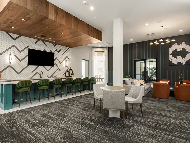 Resident Lounge with Bold Accent Wall, Bar Seating, and Comfortable Social Gathering Areas