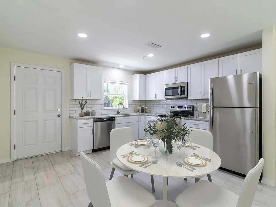 Stainless appliances, granite counter, over the range microwave.
