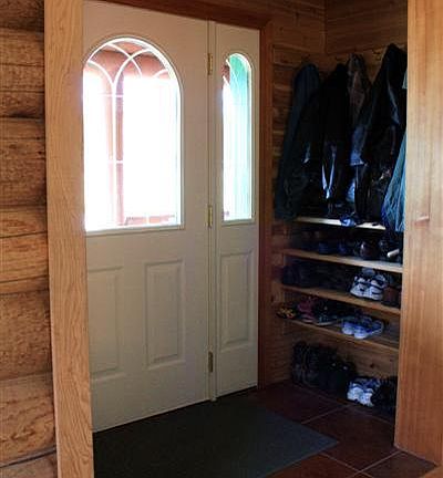 Nice mudroom entry at front door, complete with shoe storage, coat racks, and seating.