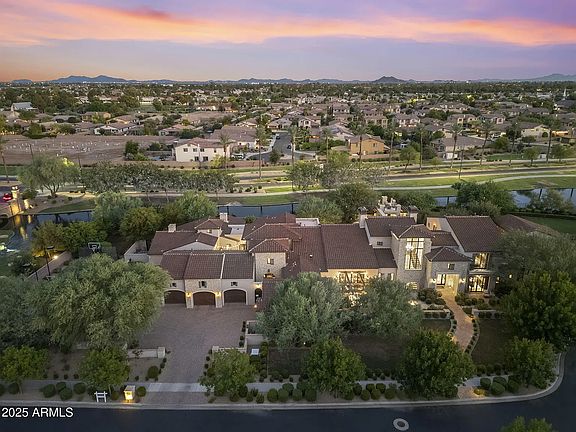 Sweeping aerial view showcasing the home's impressive footprint, private lot, and beautifully maintained surroundings.